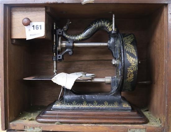 A Victorian Newton Wilson & Co sewing machine, with contemporary manual